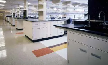 Laboratory benches with black worktops and white base cabinets